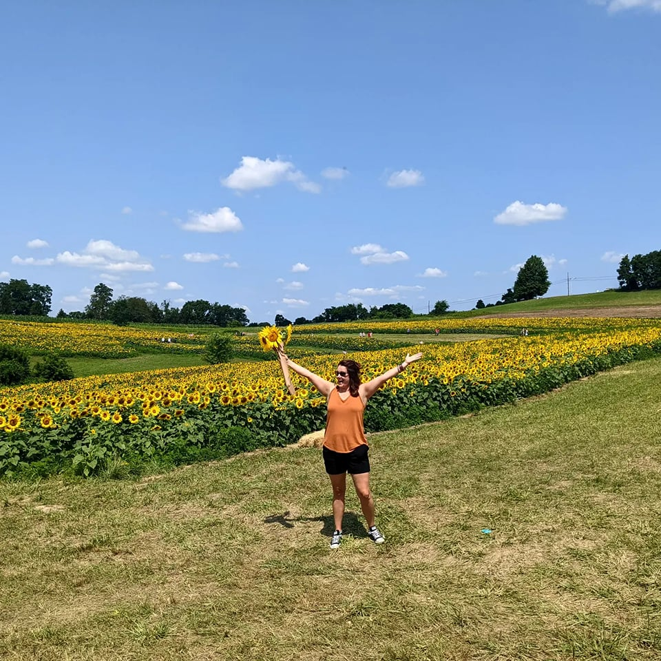 Librarian in field with sunflowers